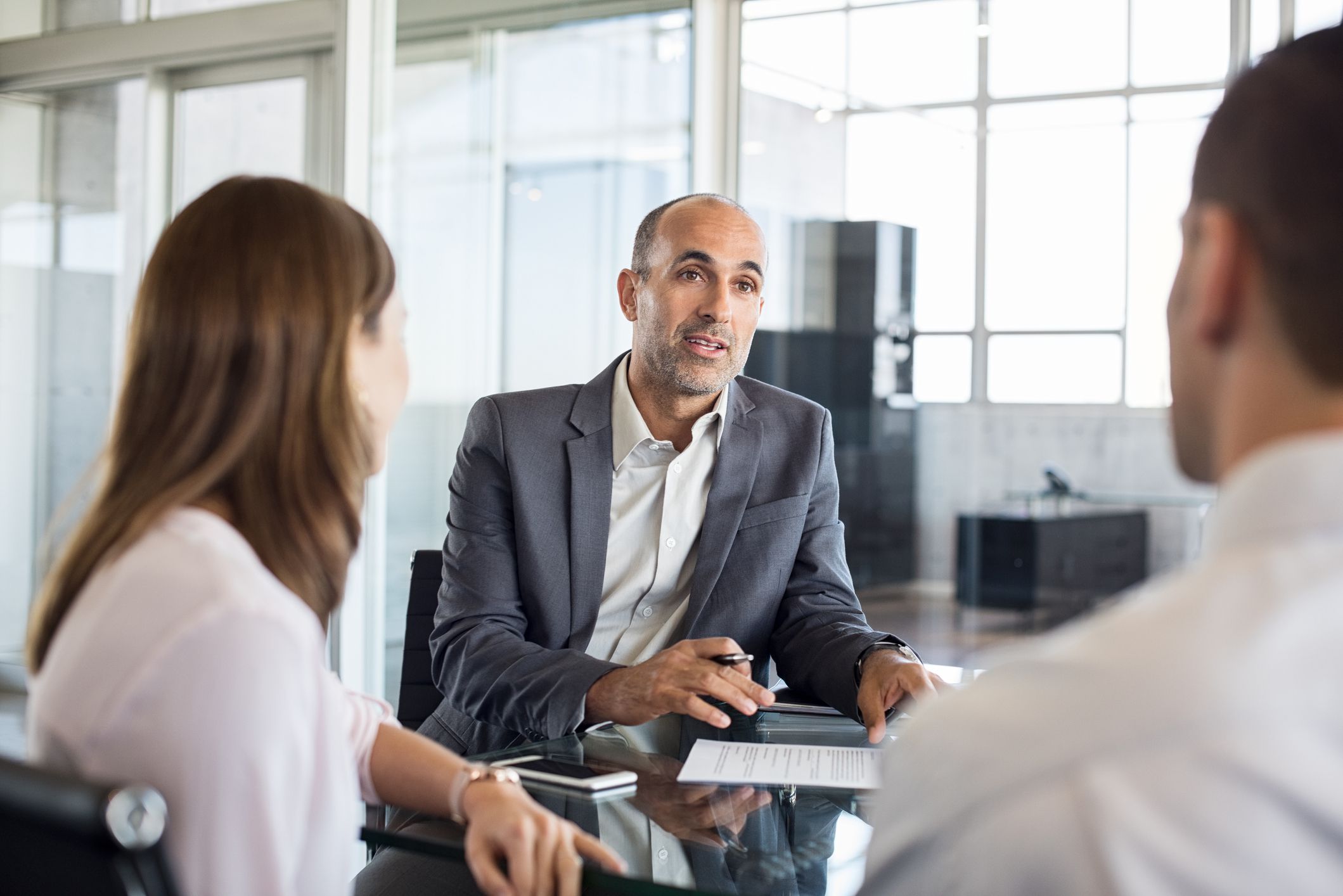 A Successful insurance agent explaining a policy to clients