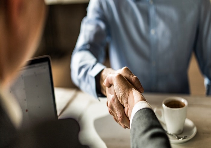 Insurance Agents shaking hands sharing new ideas to get clients